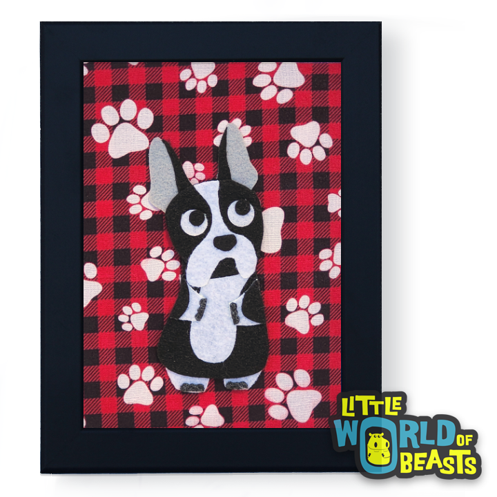 Framed artwork of a Boston terrier dog on a red plaid background with paw prints