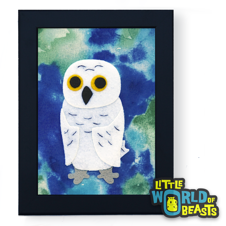 Framed artwork of a white owl on a blue and green watercolor style print background 